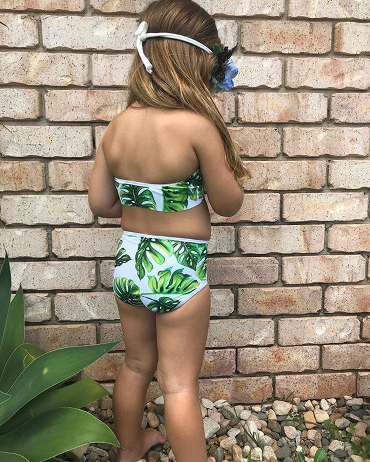 Baby girls 2-piece swimsuit featuring a tropical leaf design, perfect for summer fun by the pool or beach.