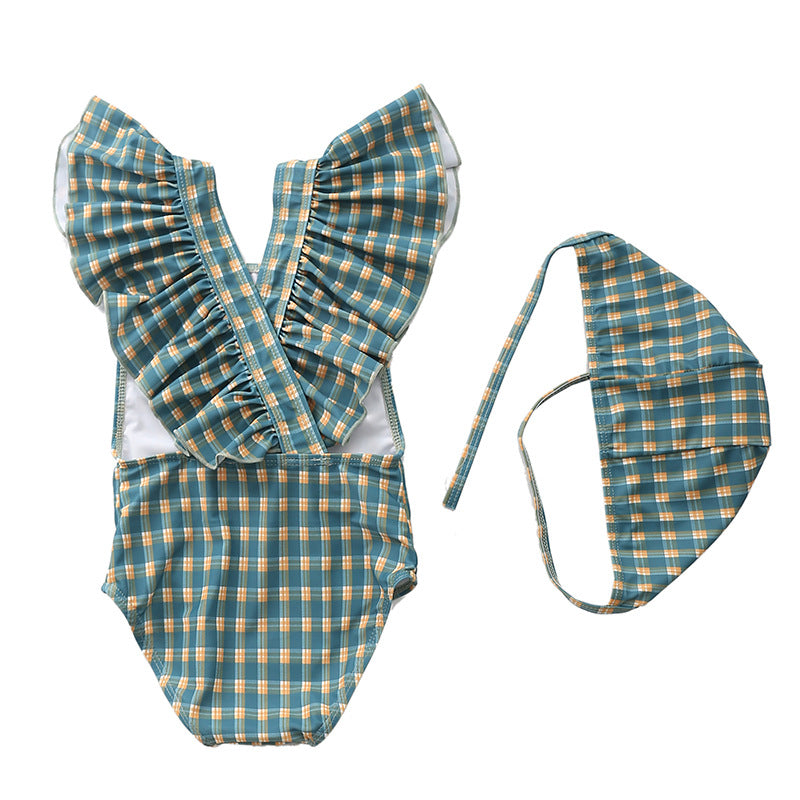 Kids and baby swimming suits with ruffle design and matching hat in plaid pattern for toddlers.