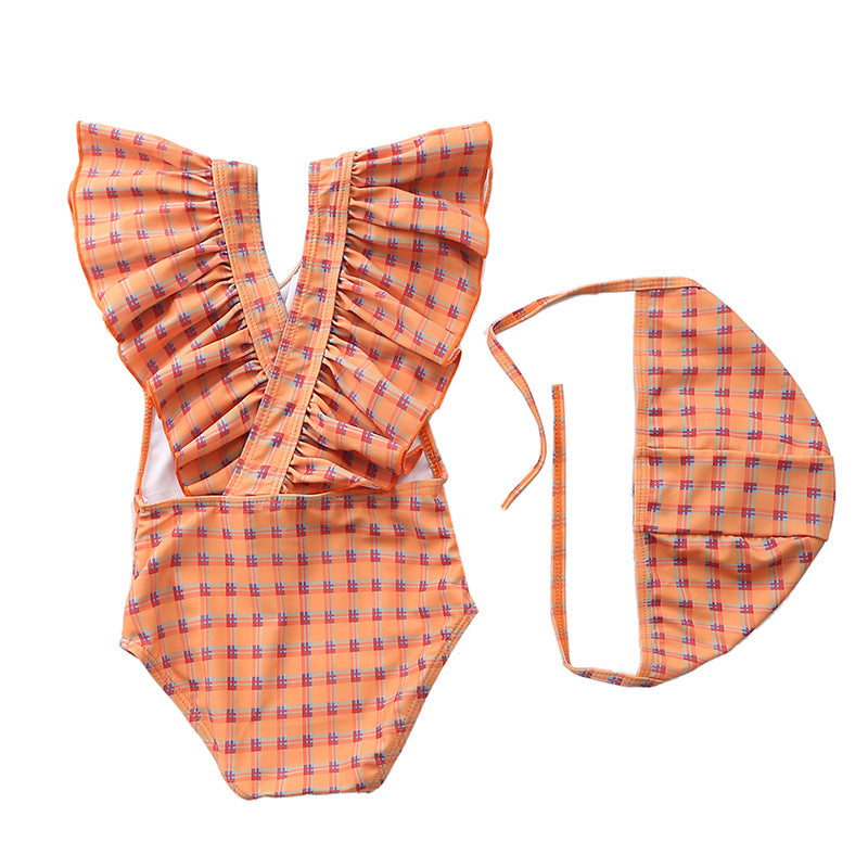 Kids and baby swimming suits featuring an orange plaid one-piece swimsuit with ruffles and matching hat for toddlers.