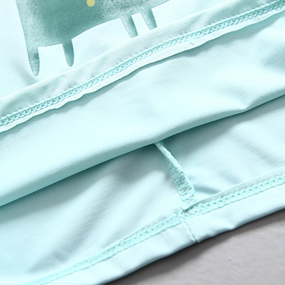 Close-up of the fabric of a boys dinosaur swimming suit, showcasing its smooth texture and stitching.