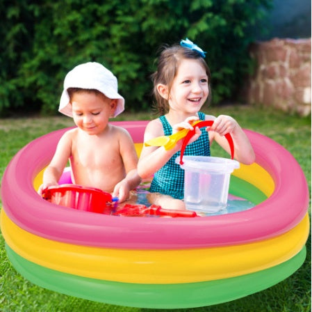 Kids inflatable paddling pool with pink, yellow, and green sides, shown with children outdoors